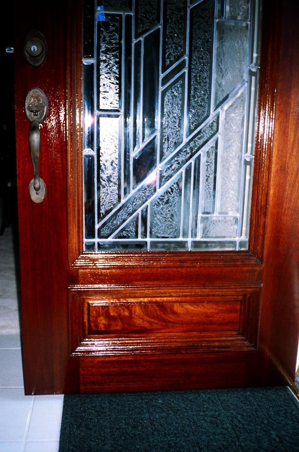 The same door restored to a rich, glossy finish after refinishing