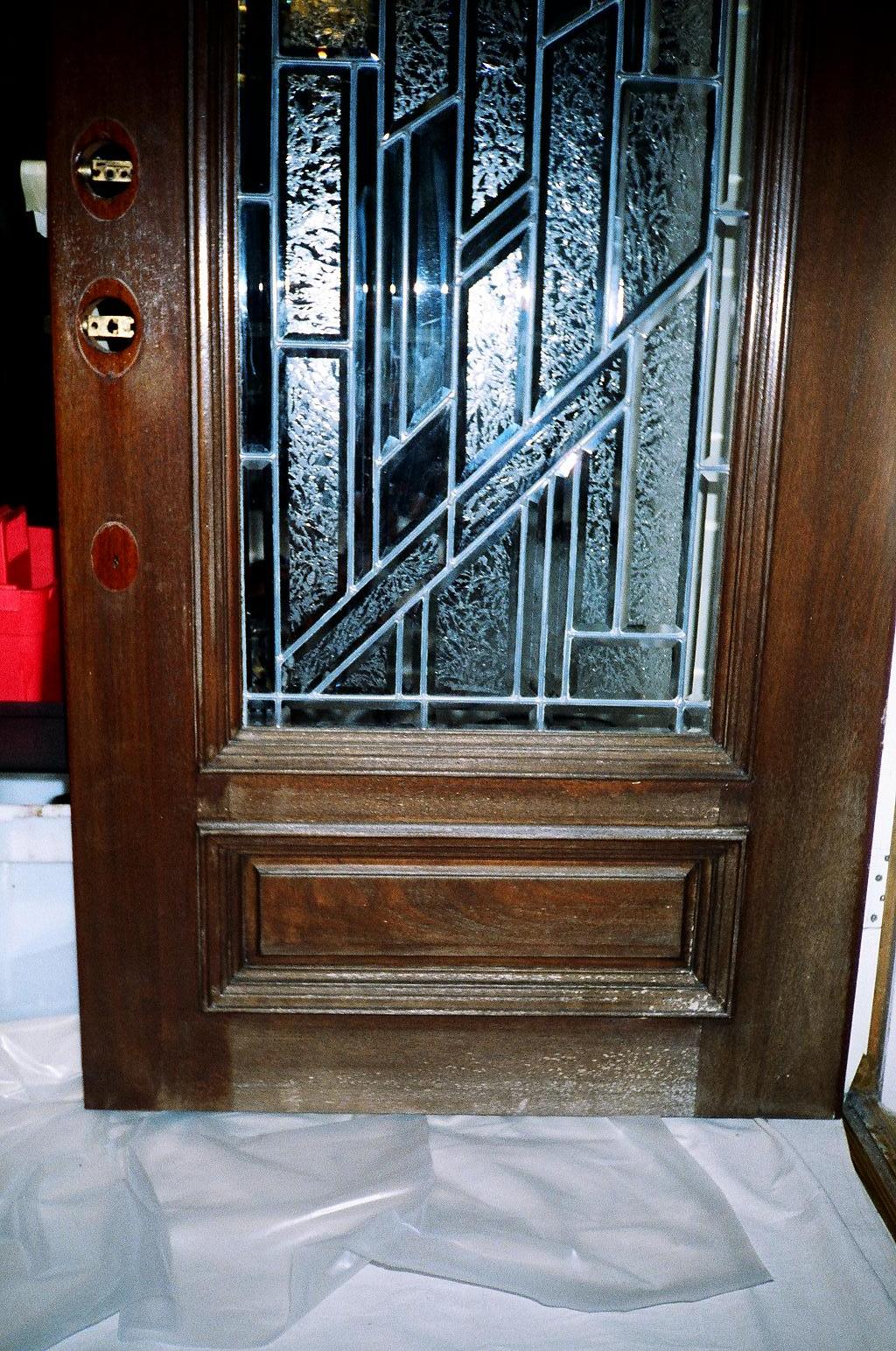 A front door with a dull, faded, weather-worn finish before refinishing